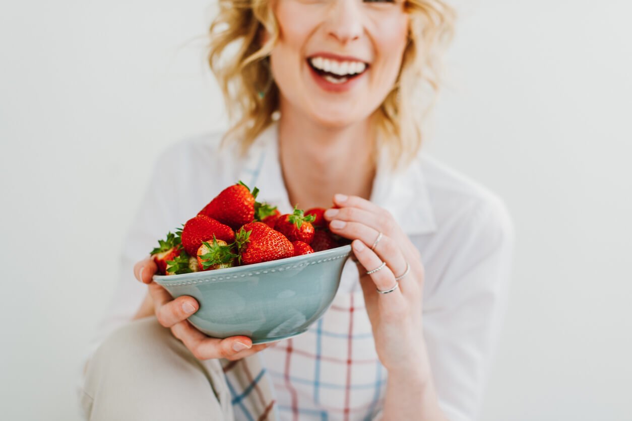 young woman eating strawberries