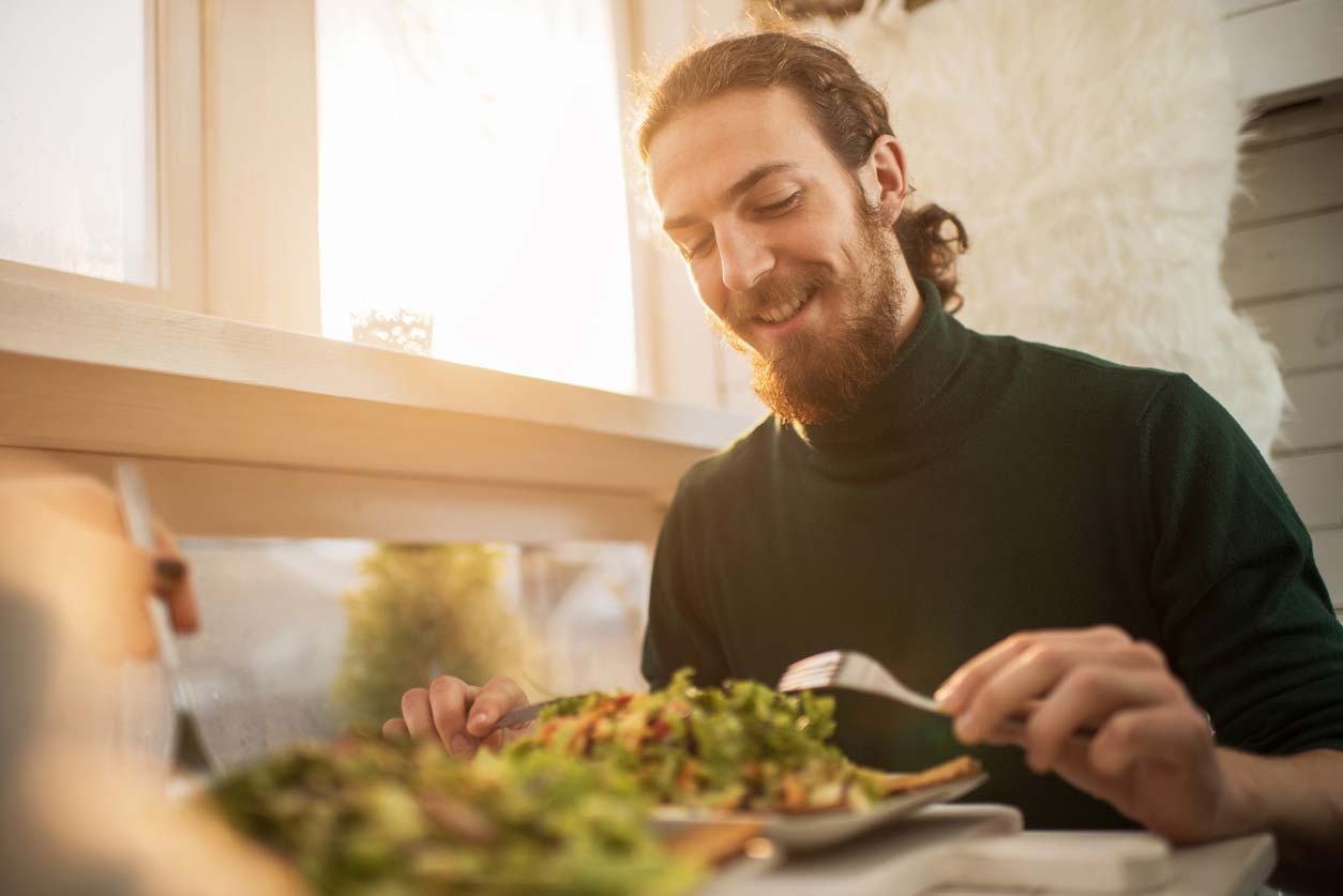 happy young man engaging in some healthy dining options