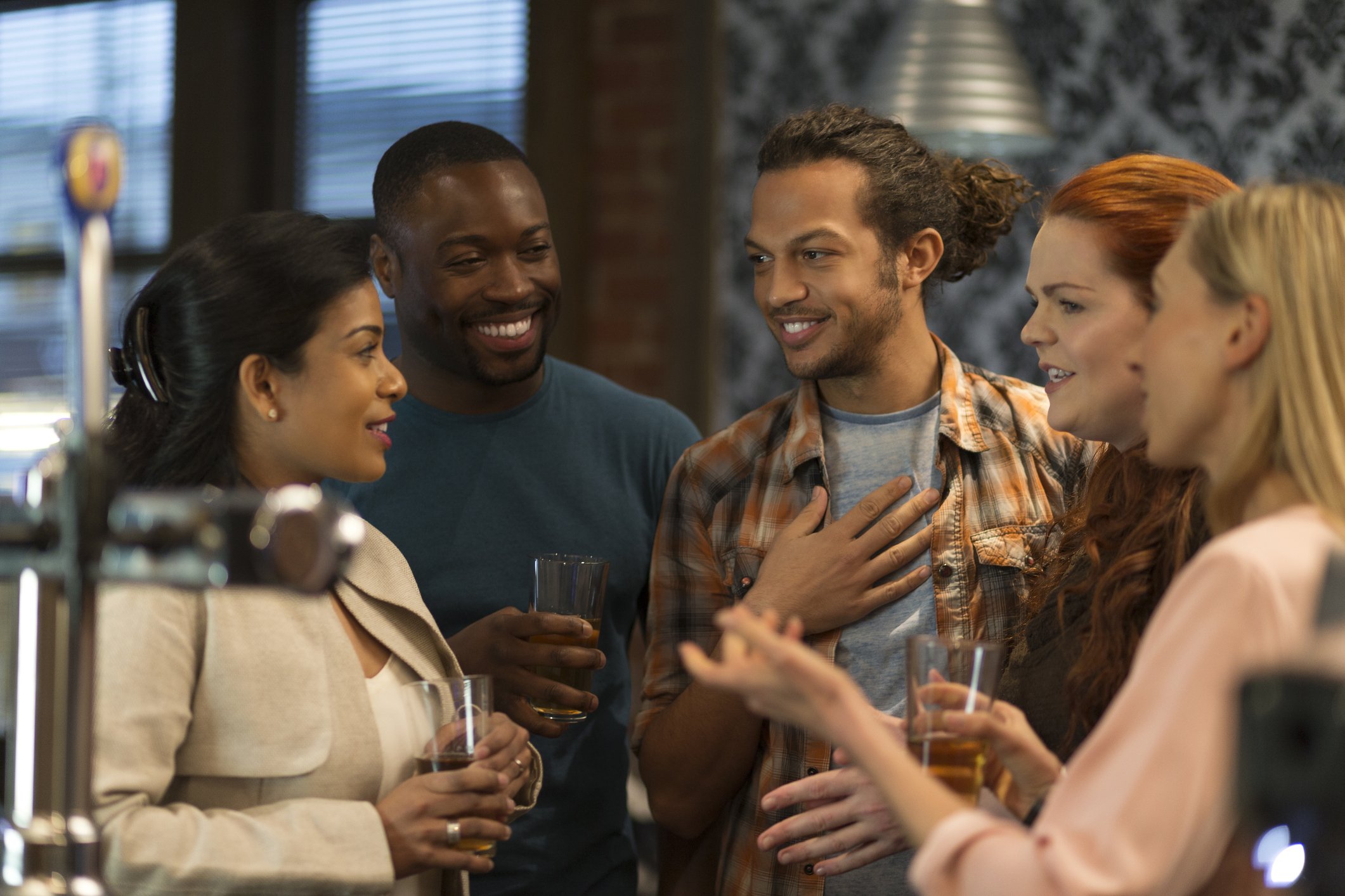 Coworkers laughing together at a bar