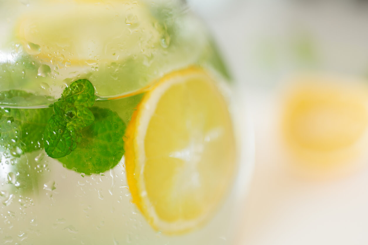fresh lemonade with lemon and peppermint leaf in jug