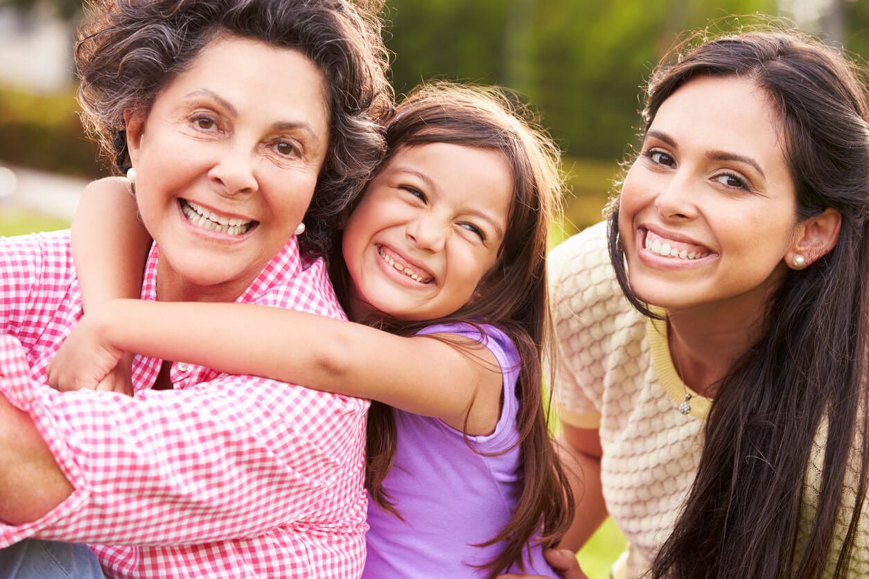 grandmother with granddaughter and mother in park 