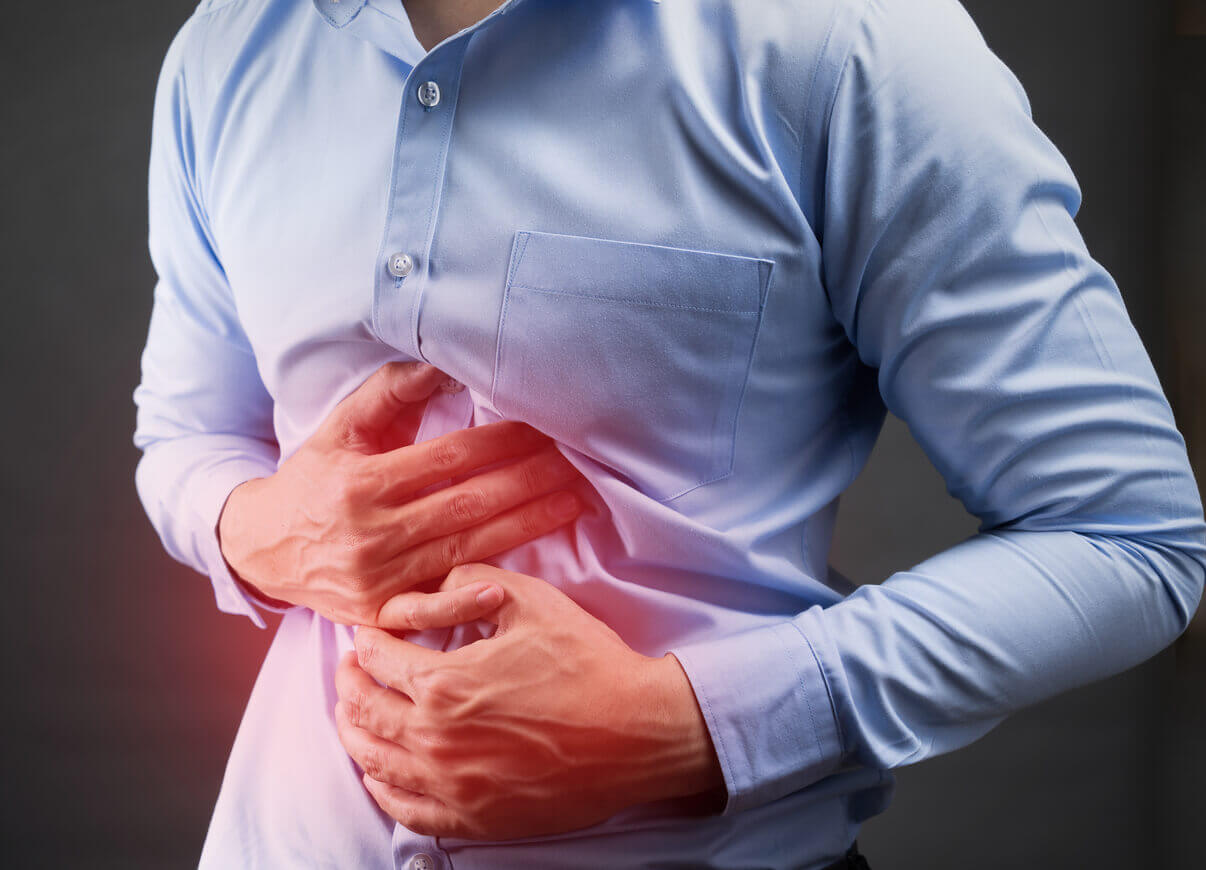 Man holding stomach in pain