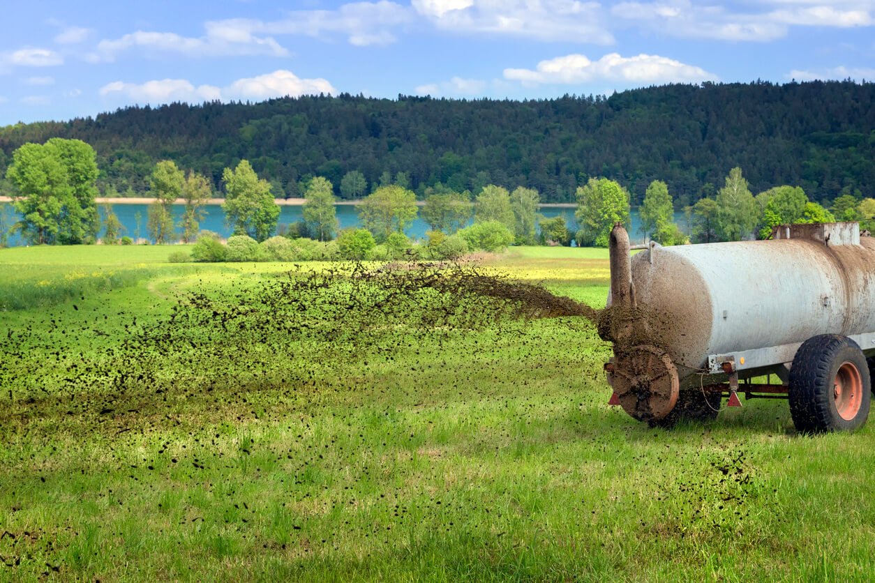 farmer spreading liquid manure