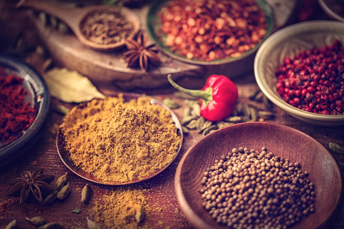 herbs and spices on wooden background