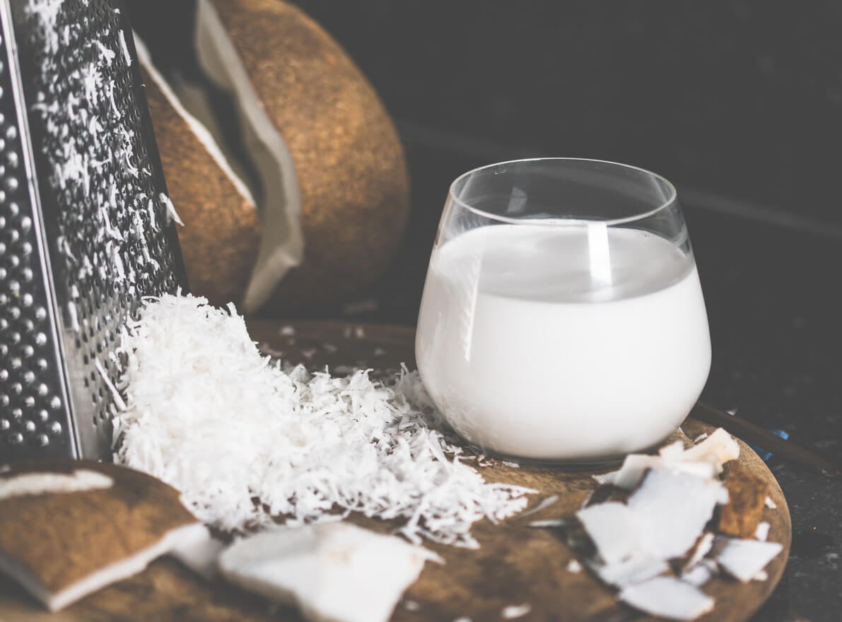glass of coconut milk on wooden table