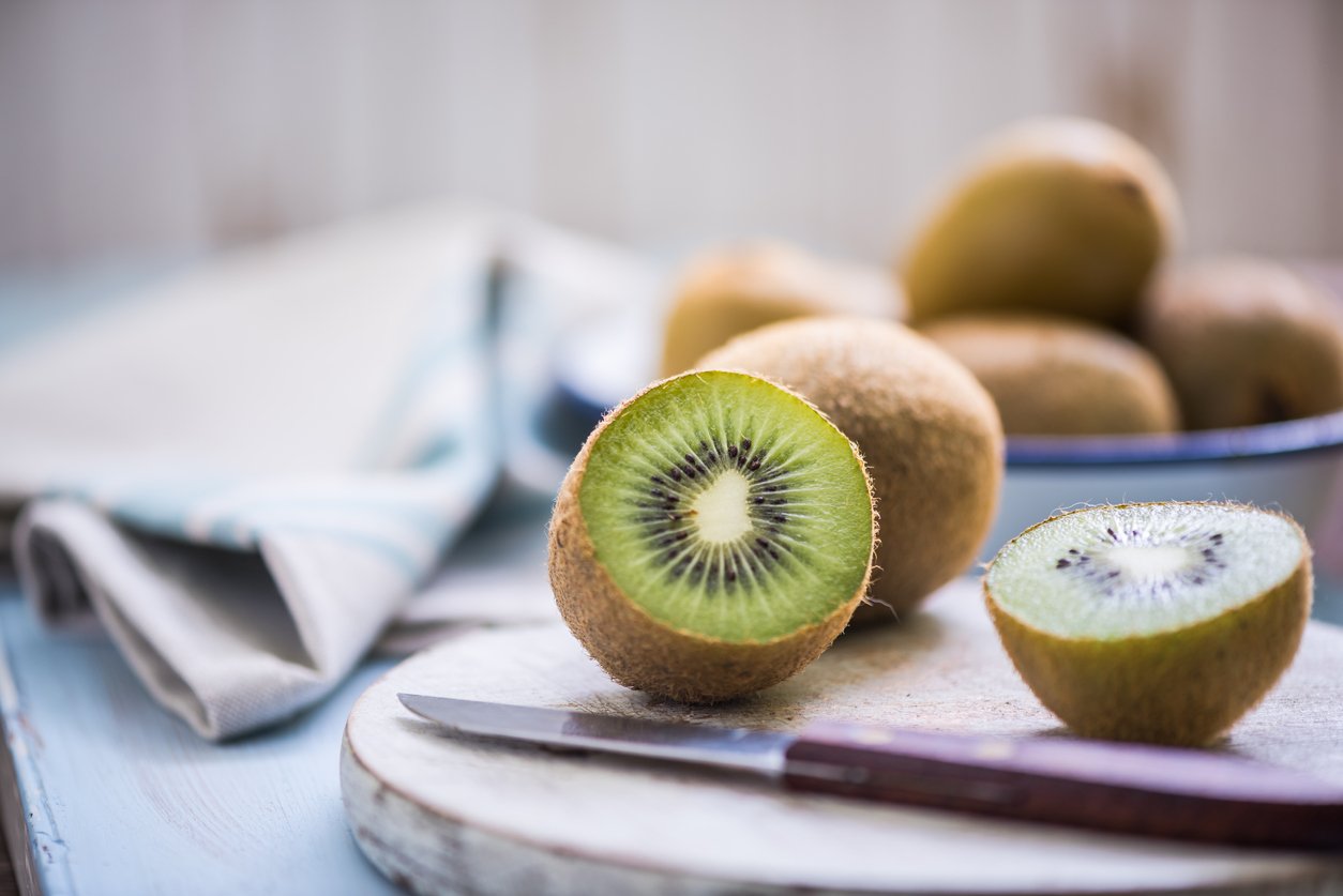 kiwi half on wooden board 