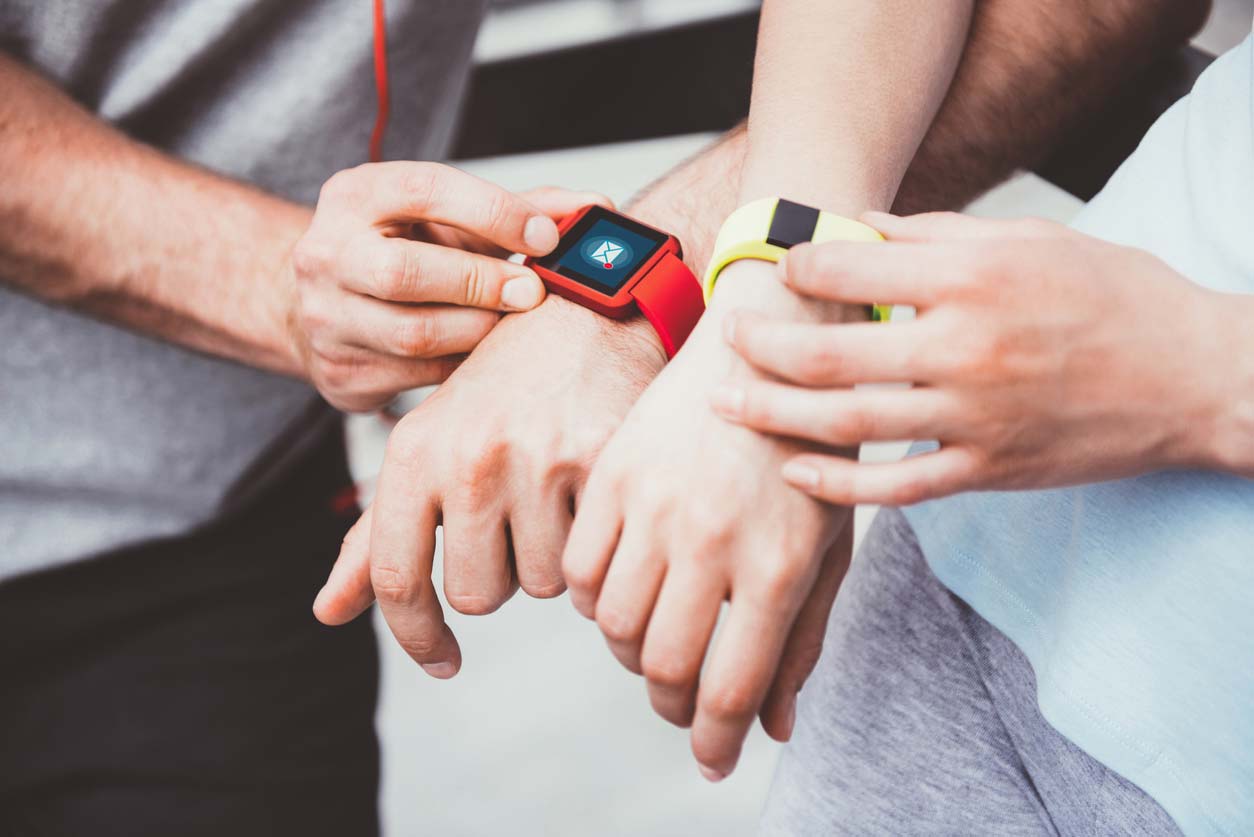 two people sharing data between their two wrist-based health trackers