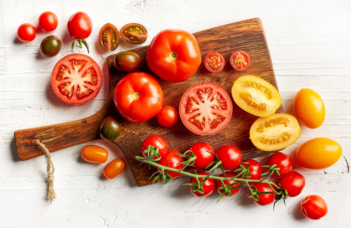 sliced tomatoes on cutting board