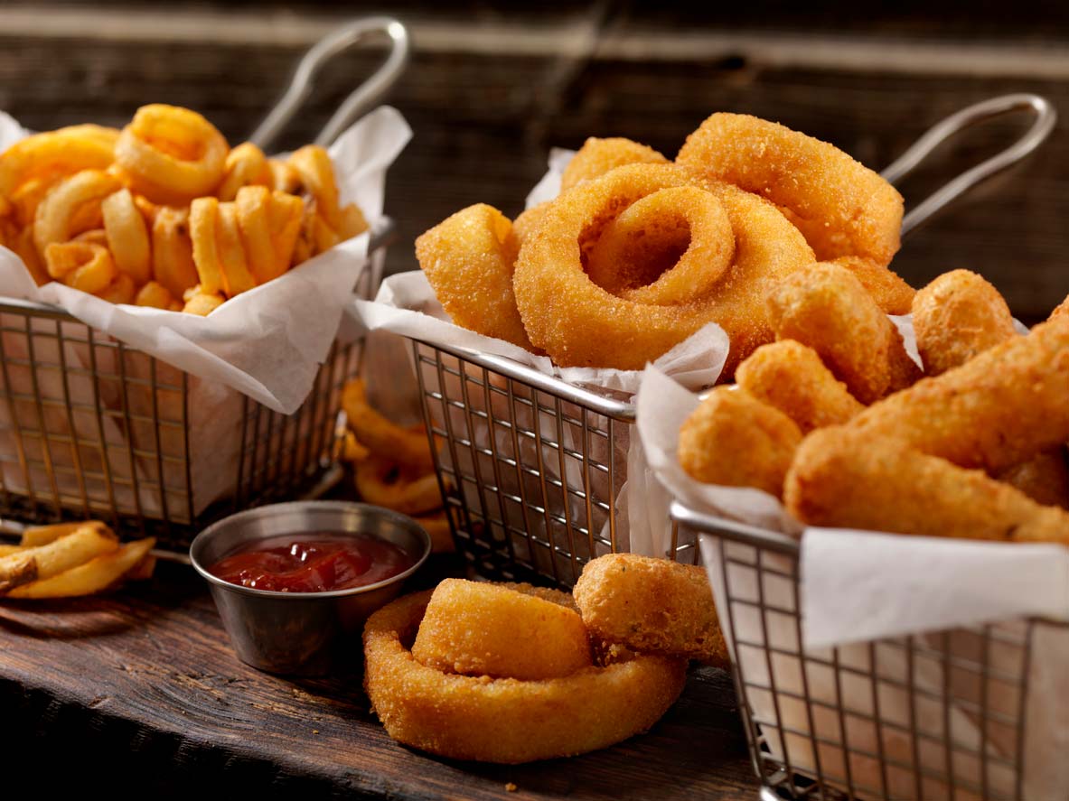 American appetizer trio: Curly fries, onion rings, and mozzarella sticks