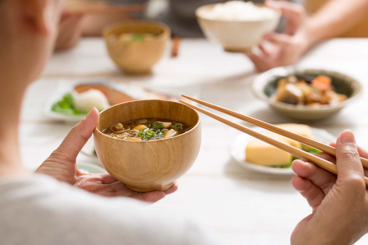 Enjoying miso in a bowl with chopsticks