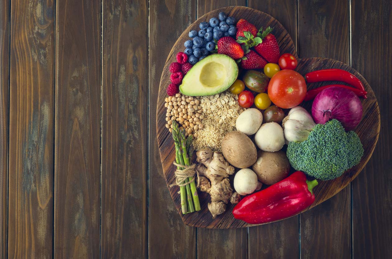 healthy food on heart shaped cutting board