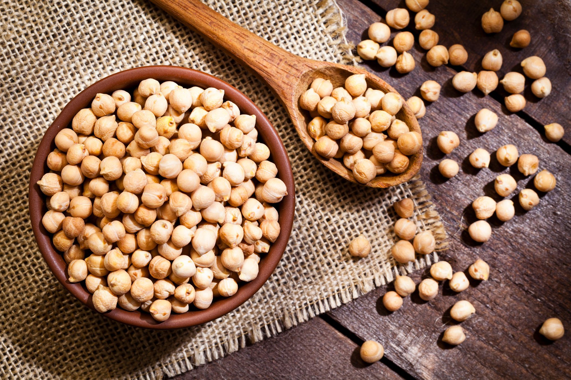 chickpeas in a bowl and wooden spoon