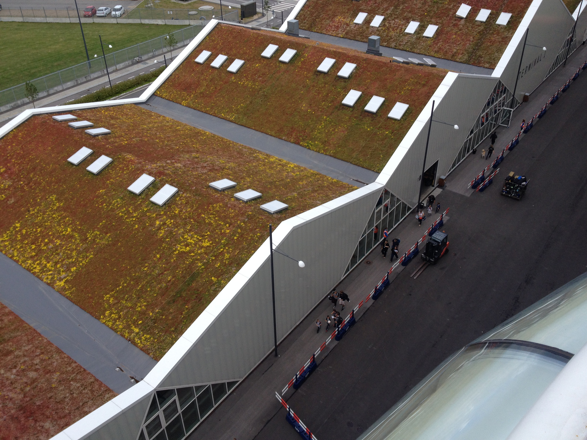Copenhagen, Denmark - 29 June 2015: Looking down on the sedum green roof of Terminal 1 Copenhagen Malmo Cruise Terminal. Solar panels and plants on a commercial rooftop. Going green.