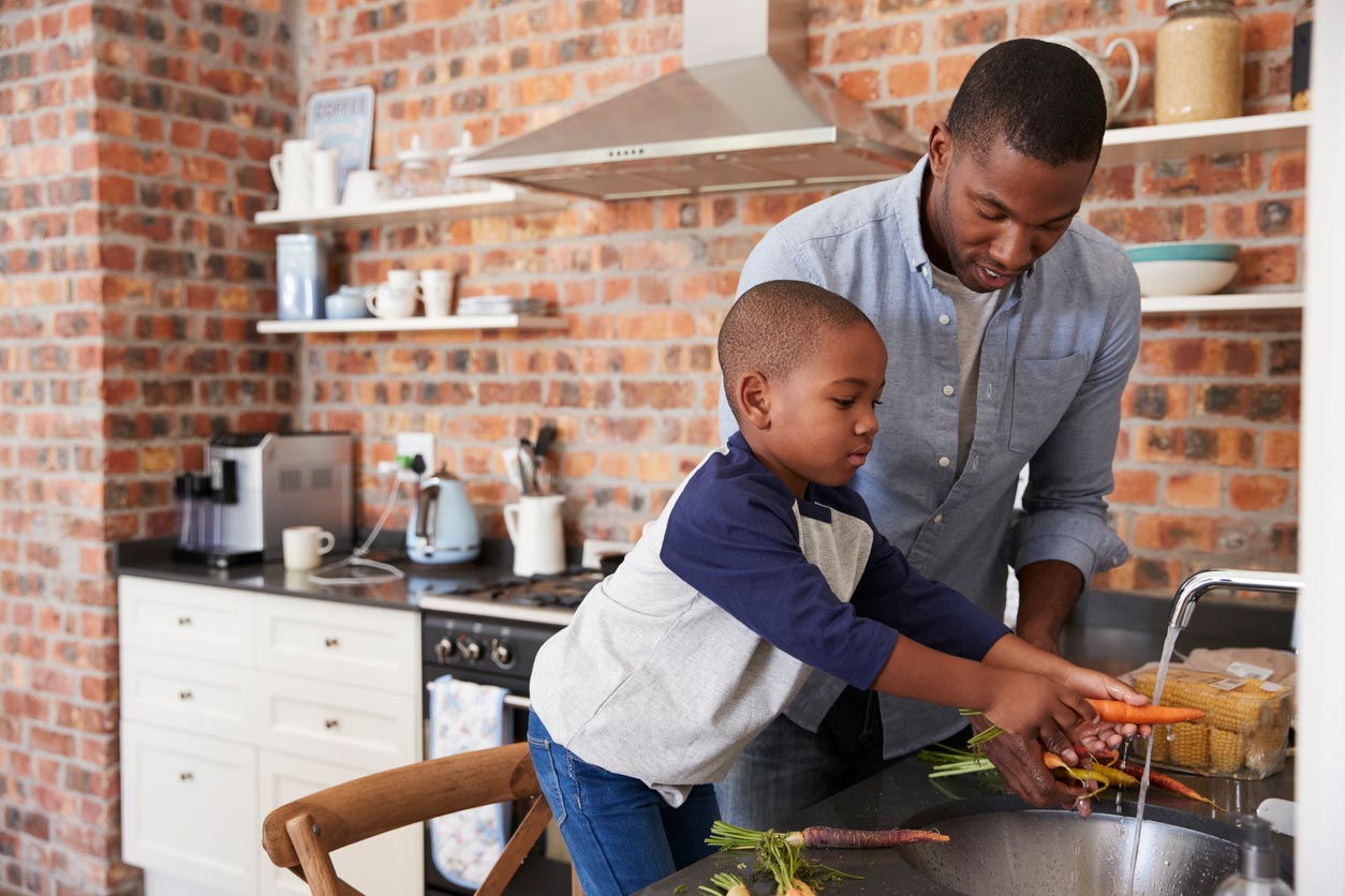 father son cooking together