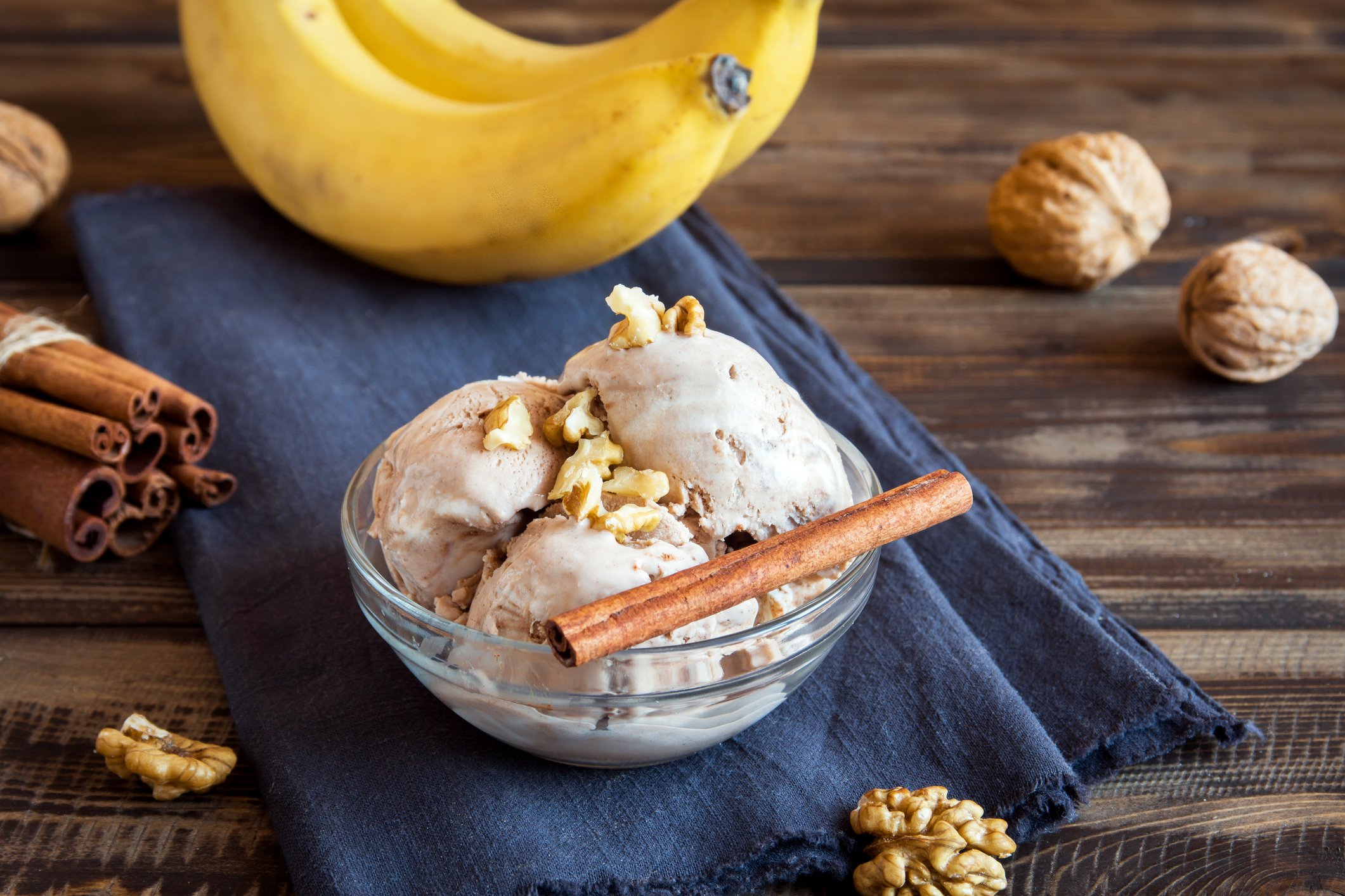 A bowl of plant-based ice cream with cinnamon nuts and bananas