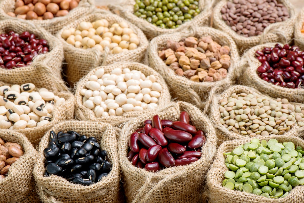 Various multicolor dry legumes in a sack cloth