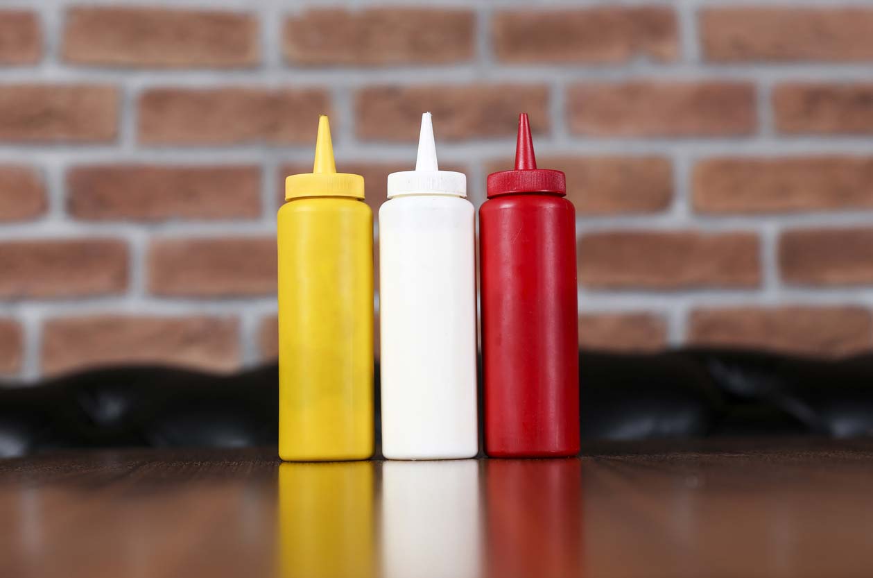 Mustard, mayo, and ketchup condiment botttles