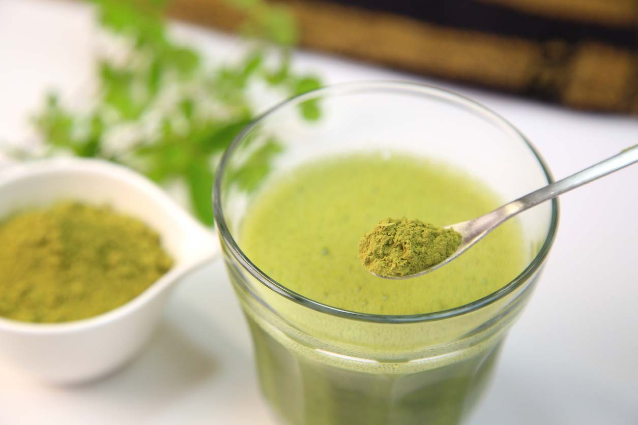 moringa powder being stirred into drink