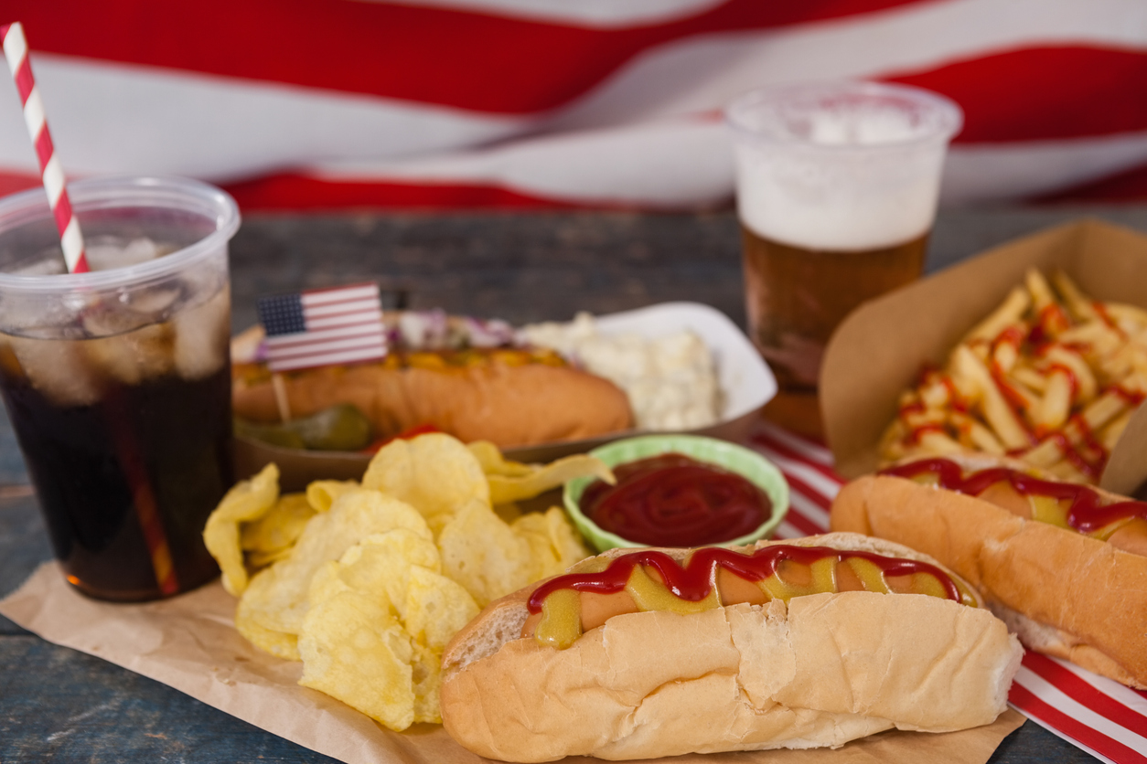 Close-up of snacks and cold drink on wooden table