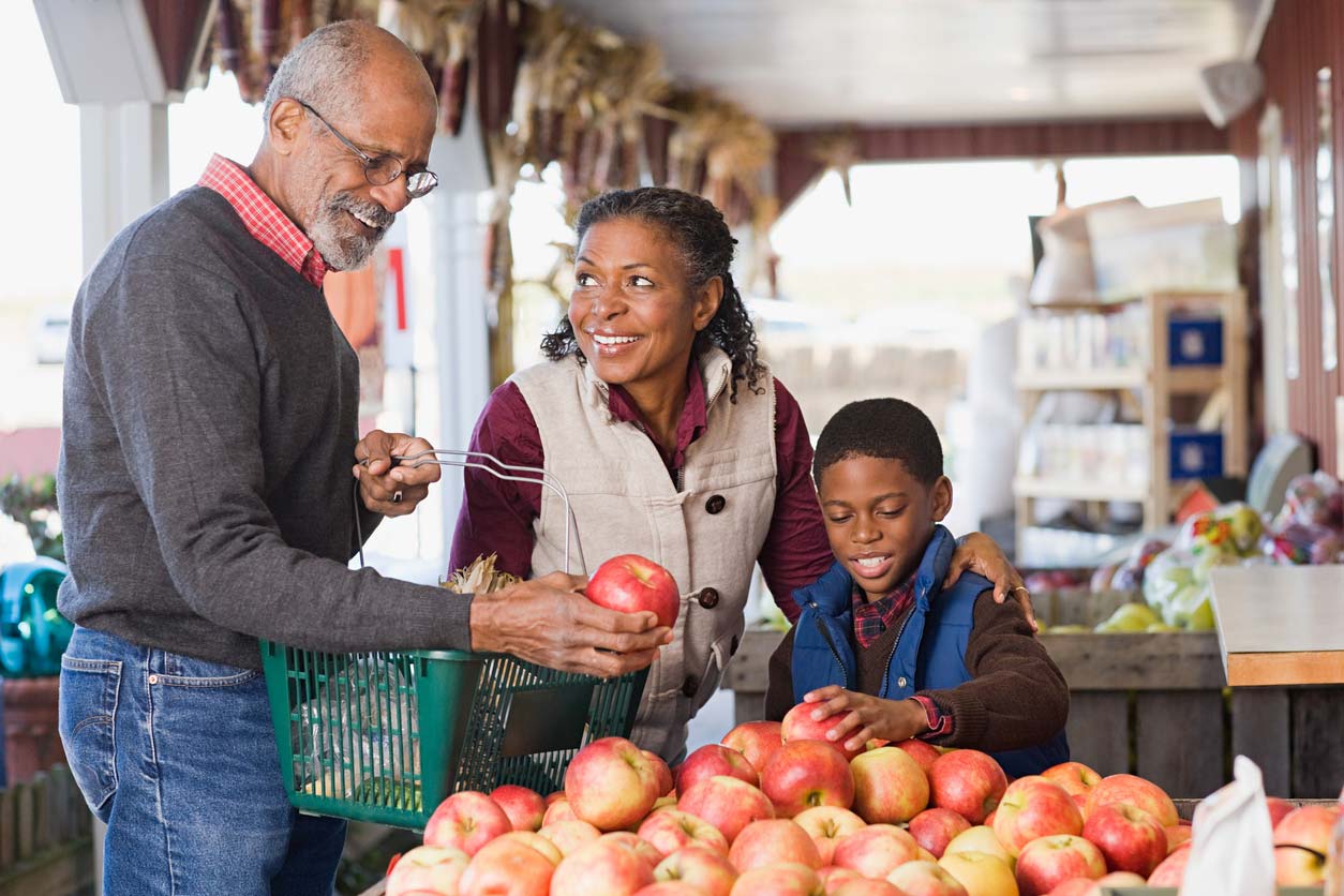 family picking apples at store