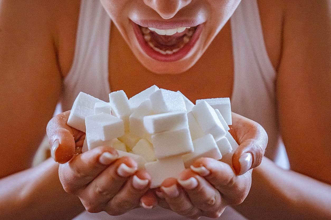 close up of woman holding a hands full of sugar cubes