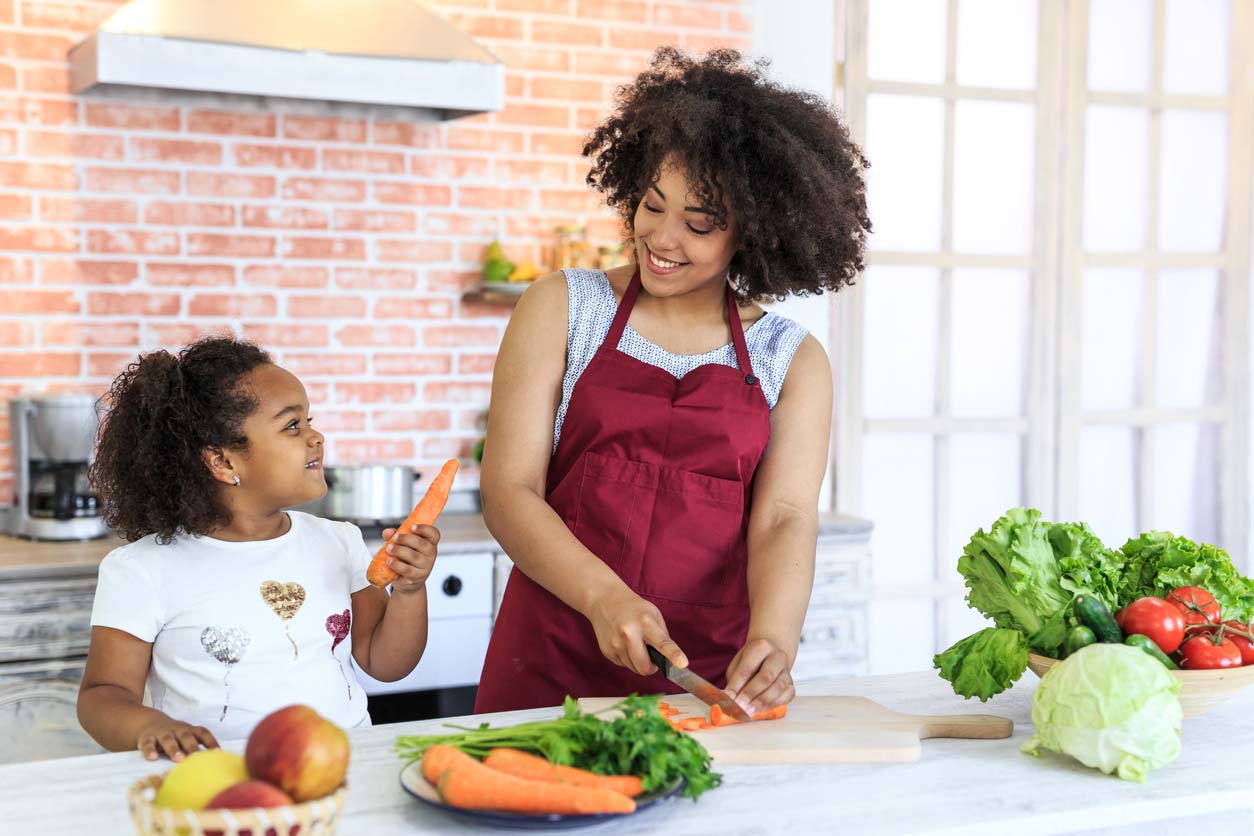 mother daughter preparing a healthy meal in the kitchen