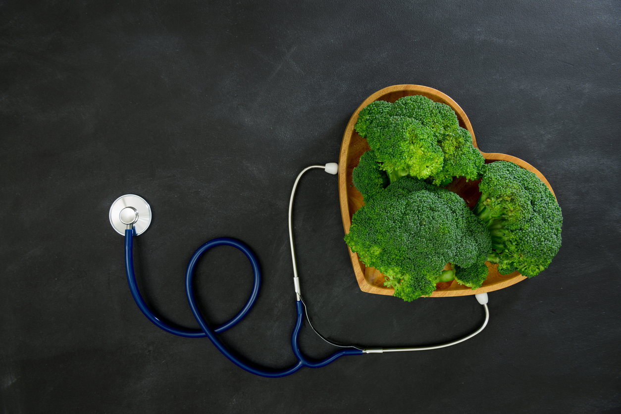 green broccoli vegetable in wooden plate as heart