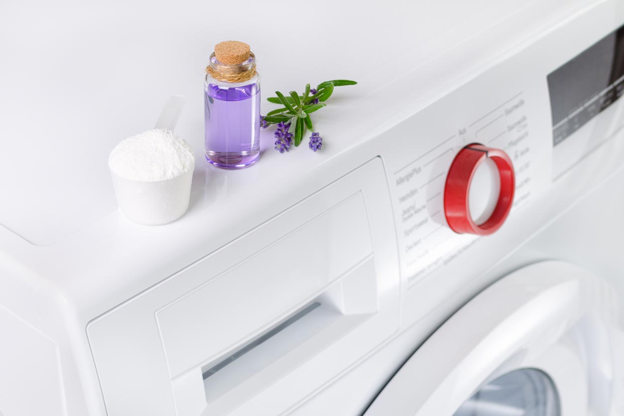 Natural laundry detergent and essential oil on washer