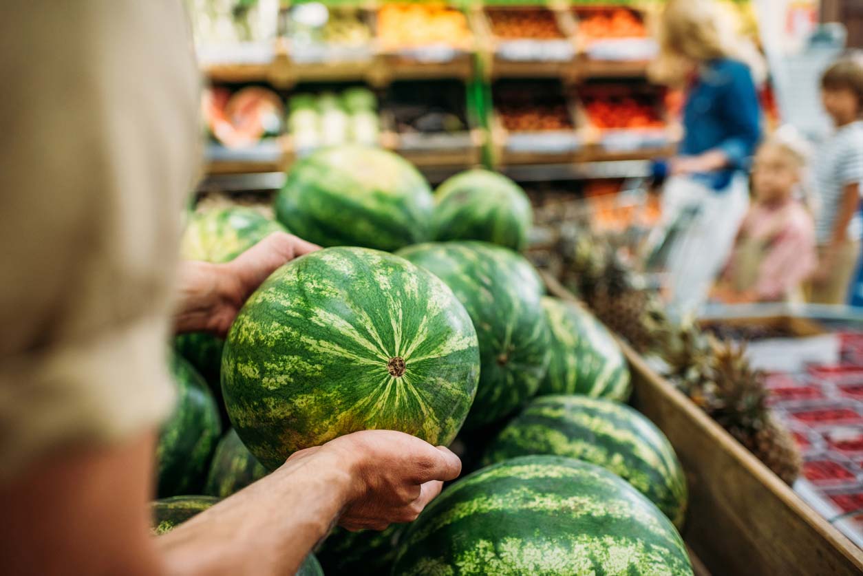 picking a watermelon at the store