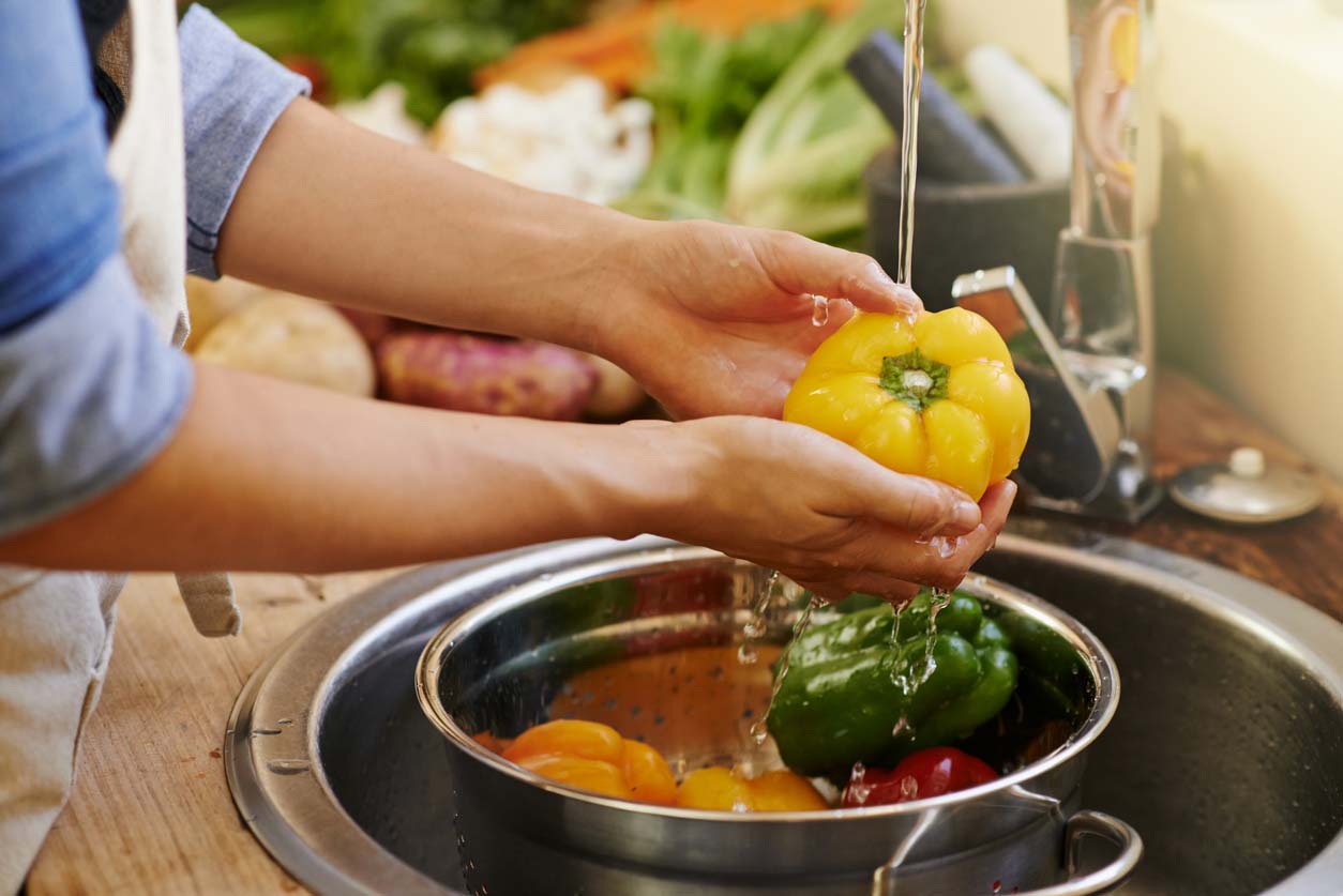 hands washing bell peppers