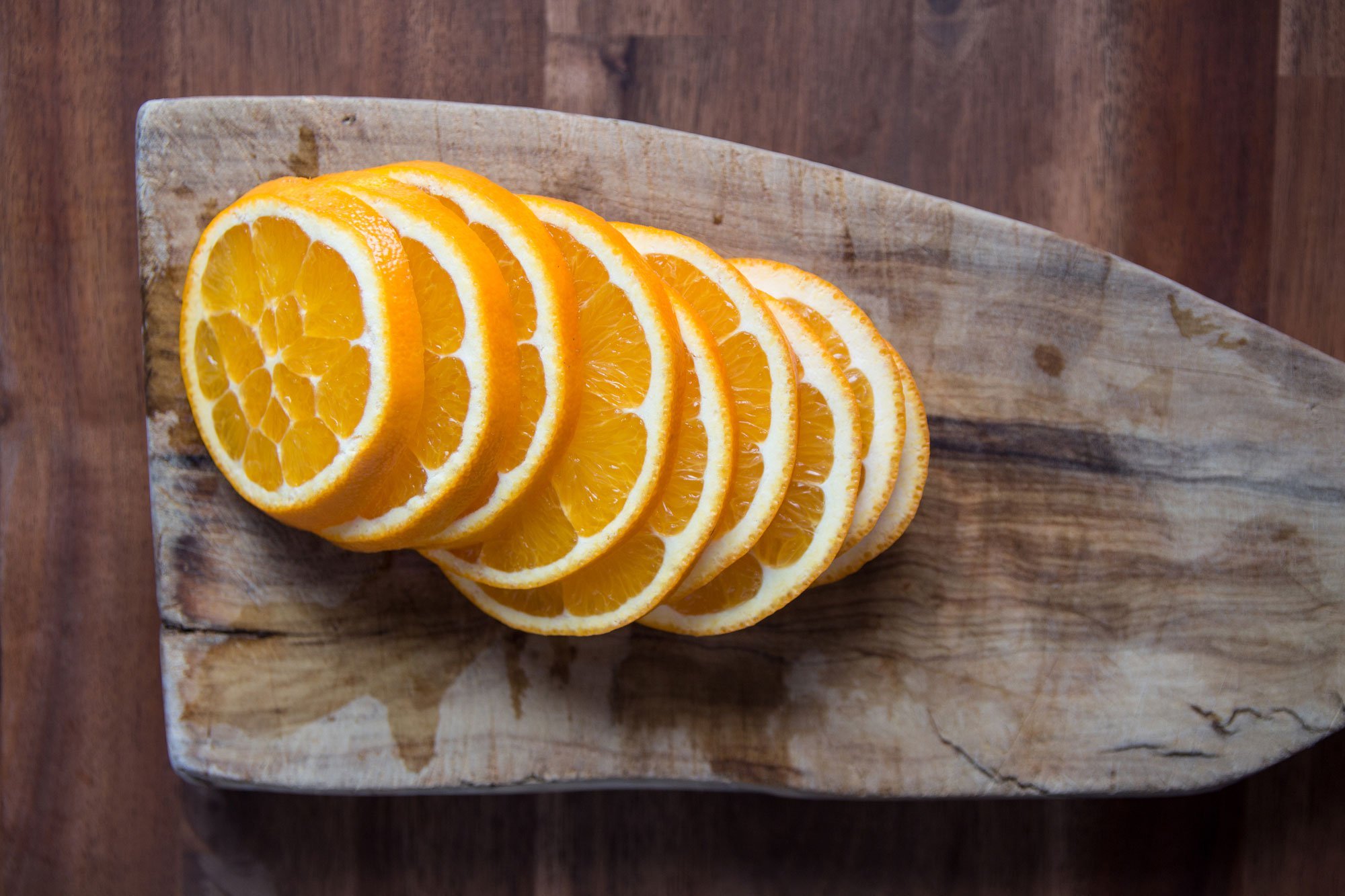 orange slices on wooden cutting board