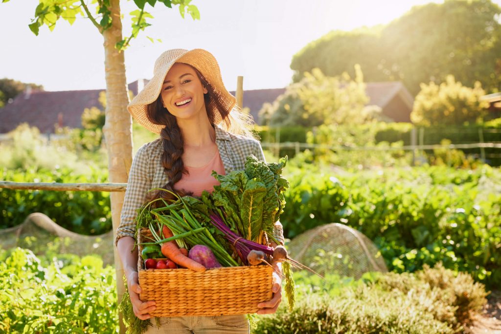 Woman carrying basket of spring produce