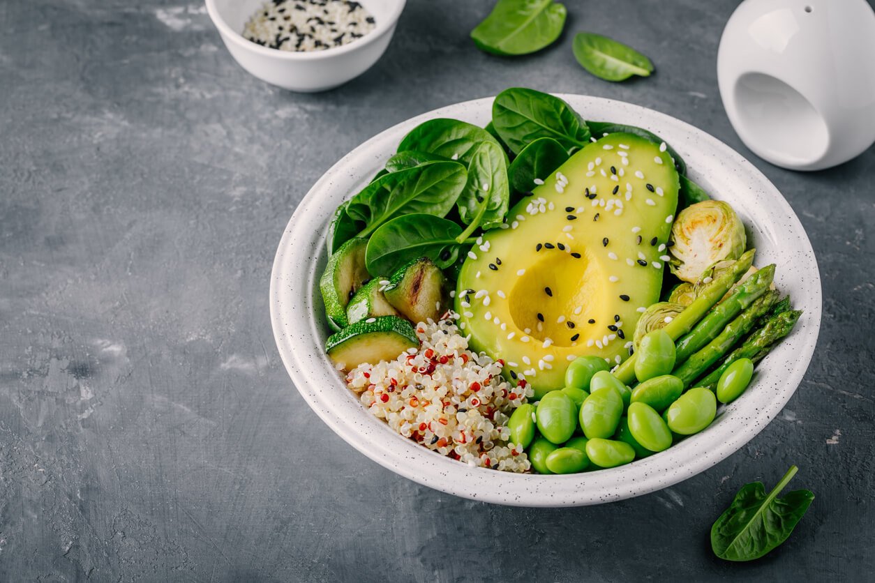 green vegetarian buddha bowl lunch with grilled vegetable and quinoa spinach avocado