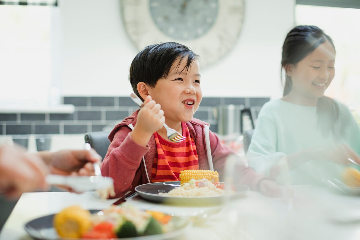 Family nutrition: little boy eating a plate full of vegetables