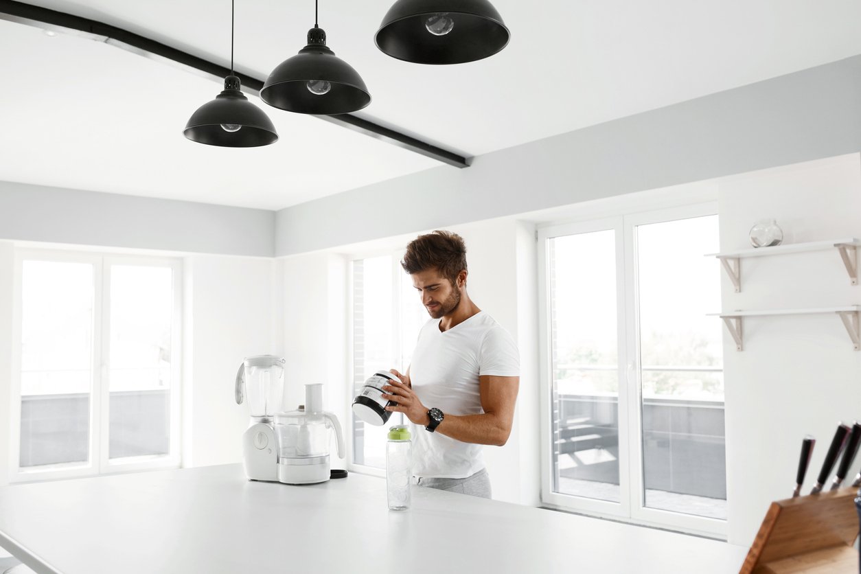 Healthy Nutrition. Man Preparing Protein Shake. Food Supplements