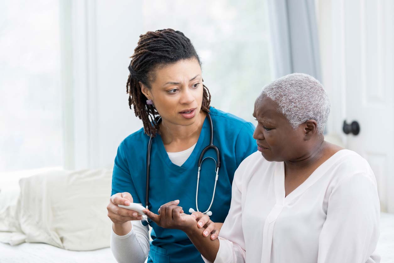 Nurse checks woman's blood sugar