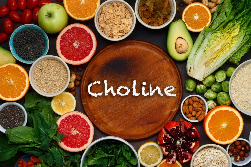 Wooden cutting board with choline text in the middle surrounded by vegan sources of choline