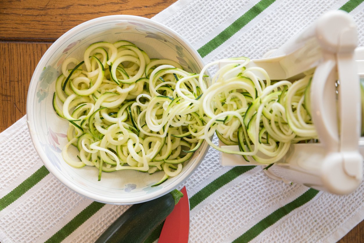 Spiral zucchini noodles called zoodles prepared in spiralizer kitchen gadget