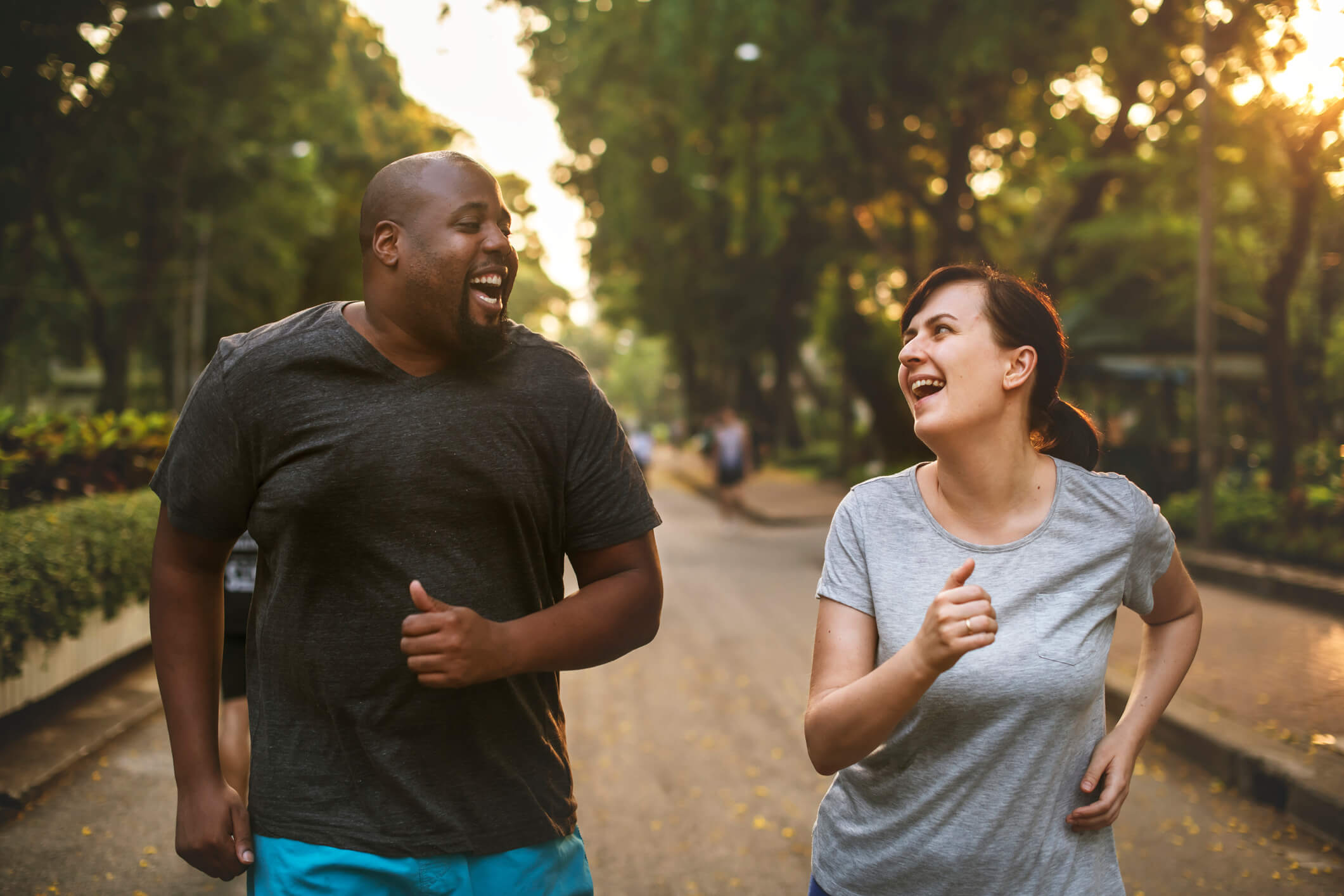 A man and woman running in a park