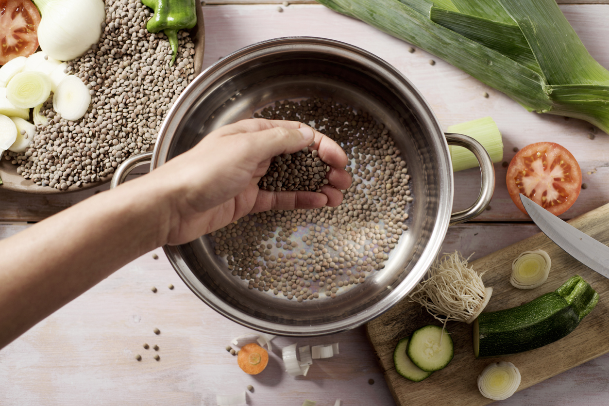 man preparing a vegetarian lentil stew