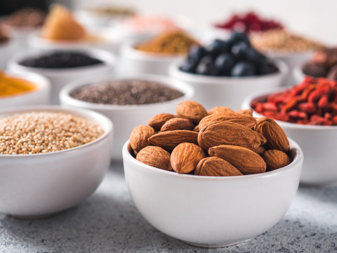 almonds in small white bowl and other superfoods