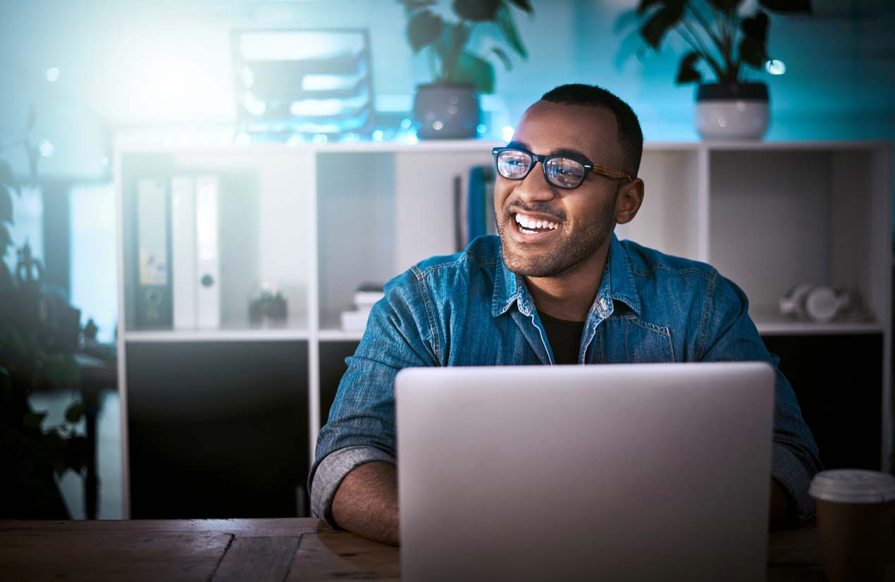 Man in glasses sitting with laptop