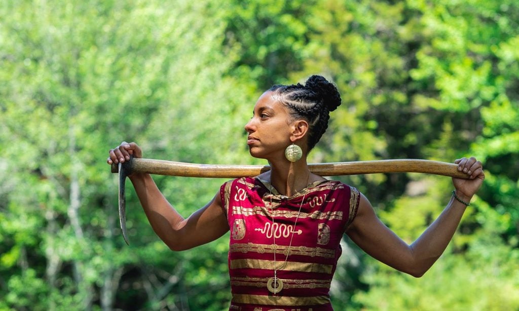 Leah Penniman holding a garden hoe