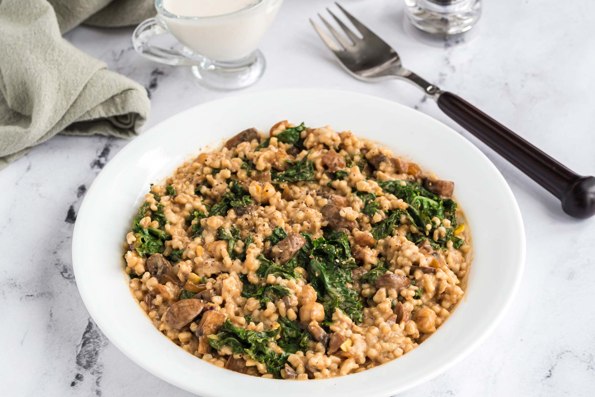 kale and mushroom oat groats in bowl