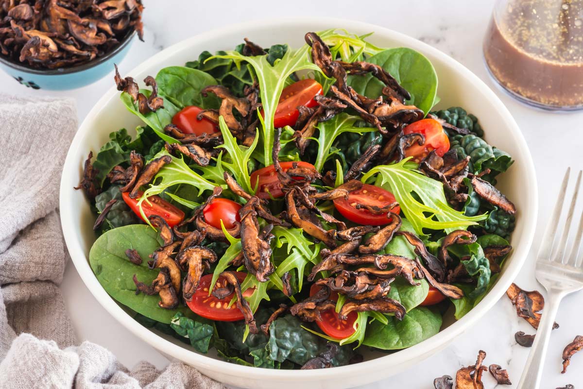 mushroom bacon topper with salad in bowl