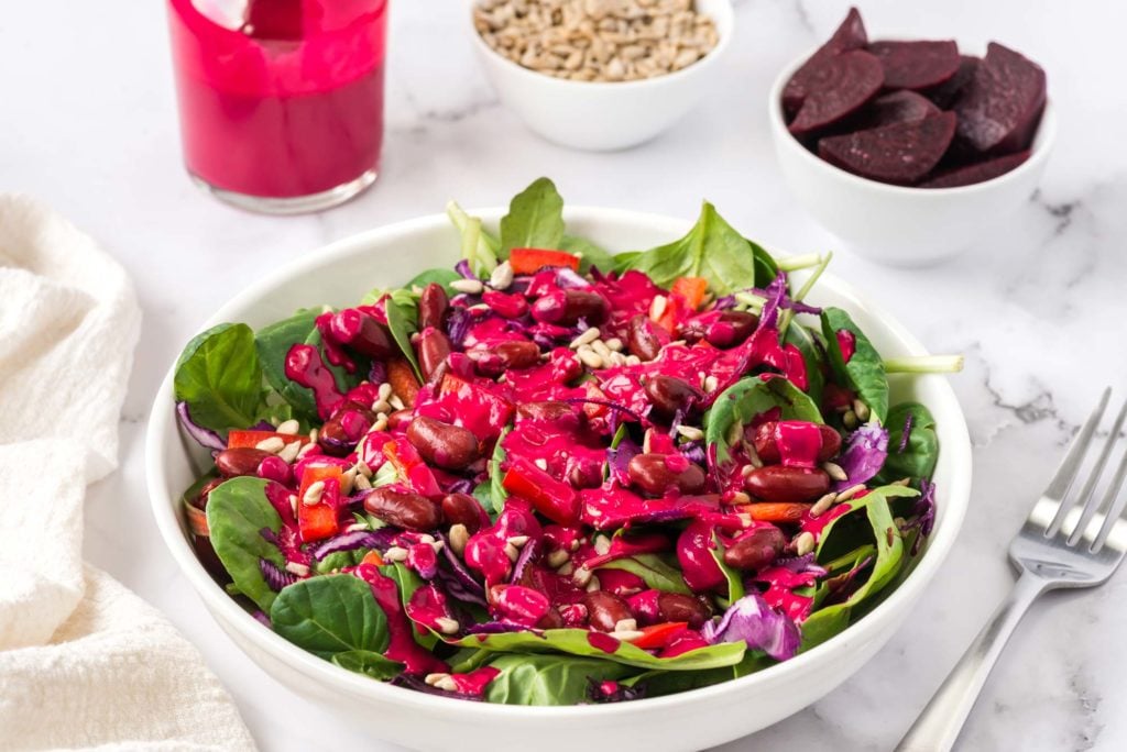 heart beets dressing on a salad in bowl