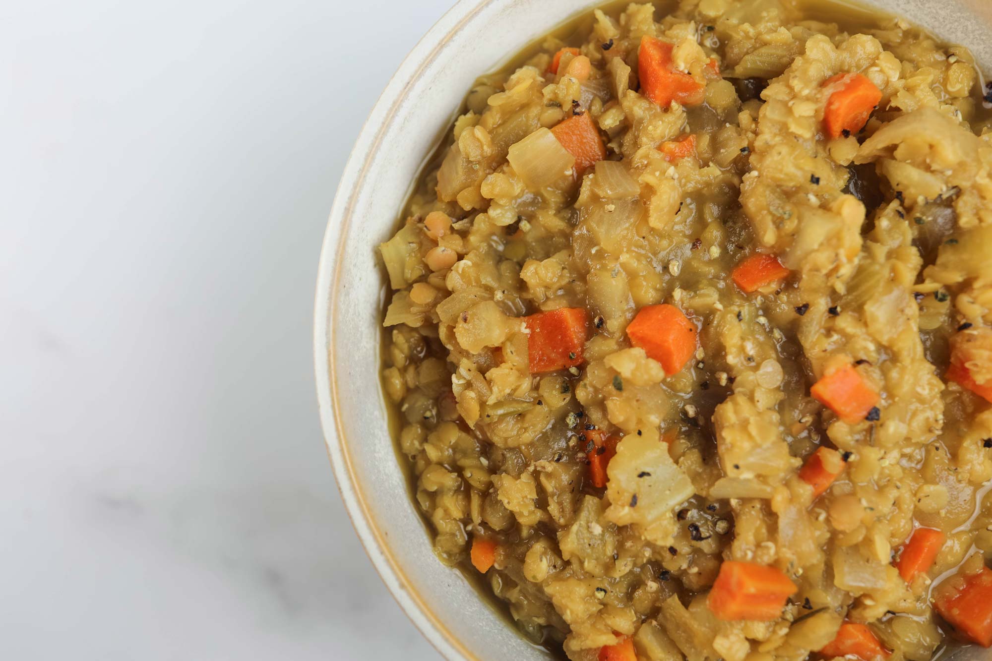 orange lentil soup with anise and coriander in bowl