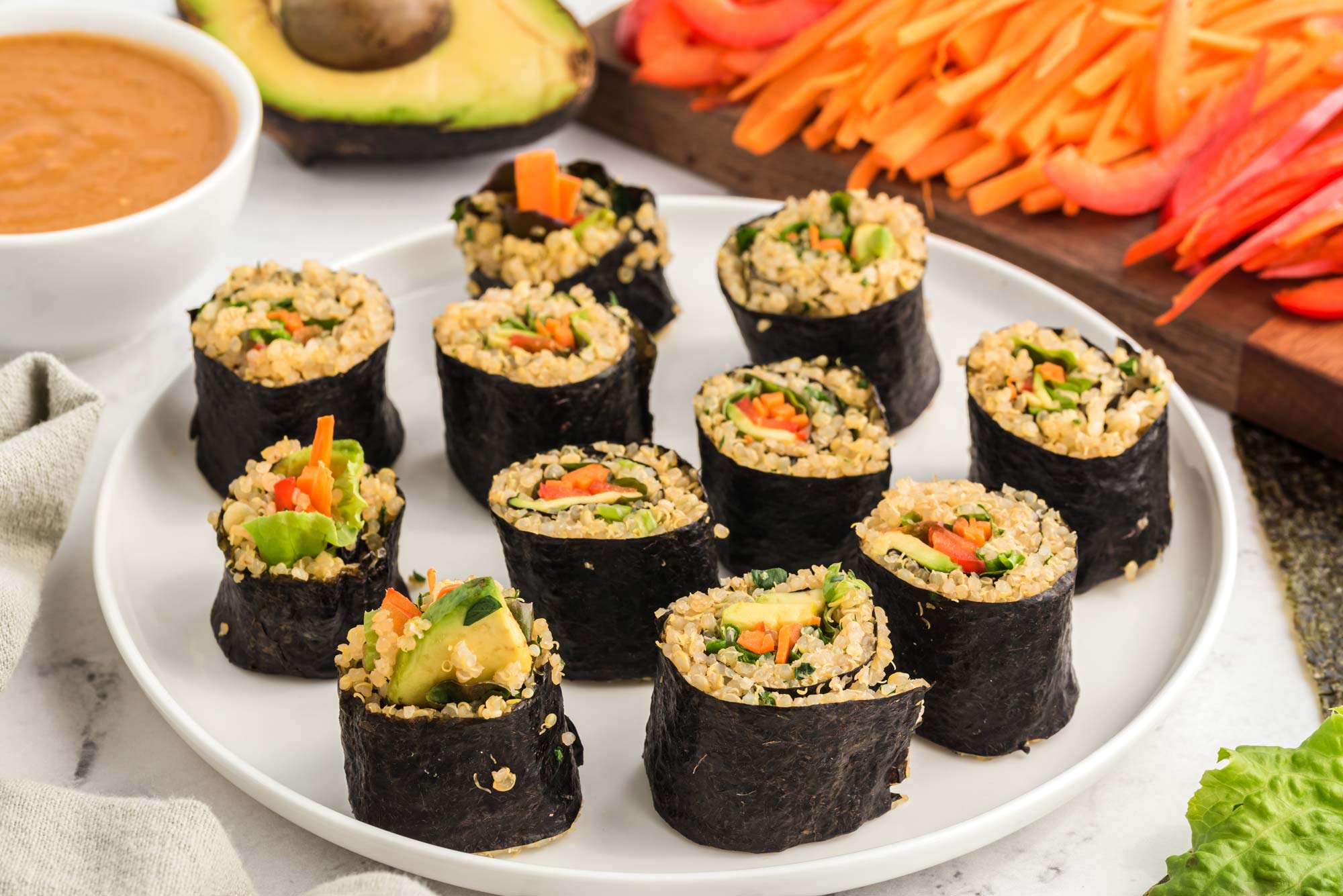 rainbow millet roll with miso peanut sauce on plate