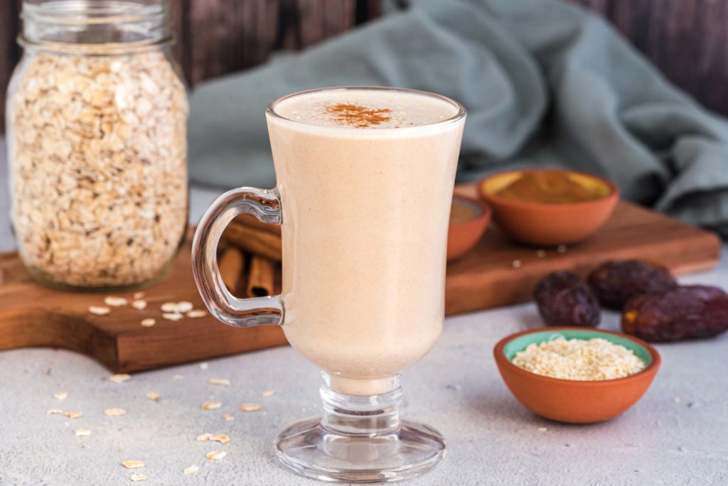 sweet and nutty oat milk with cinnamon in glass