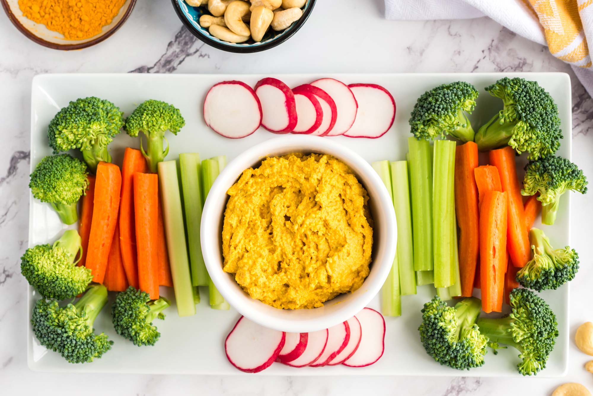 turmeric cashew cheese in bowl with assorted veggies